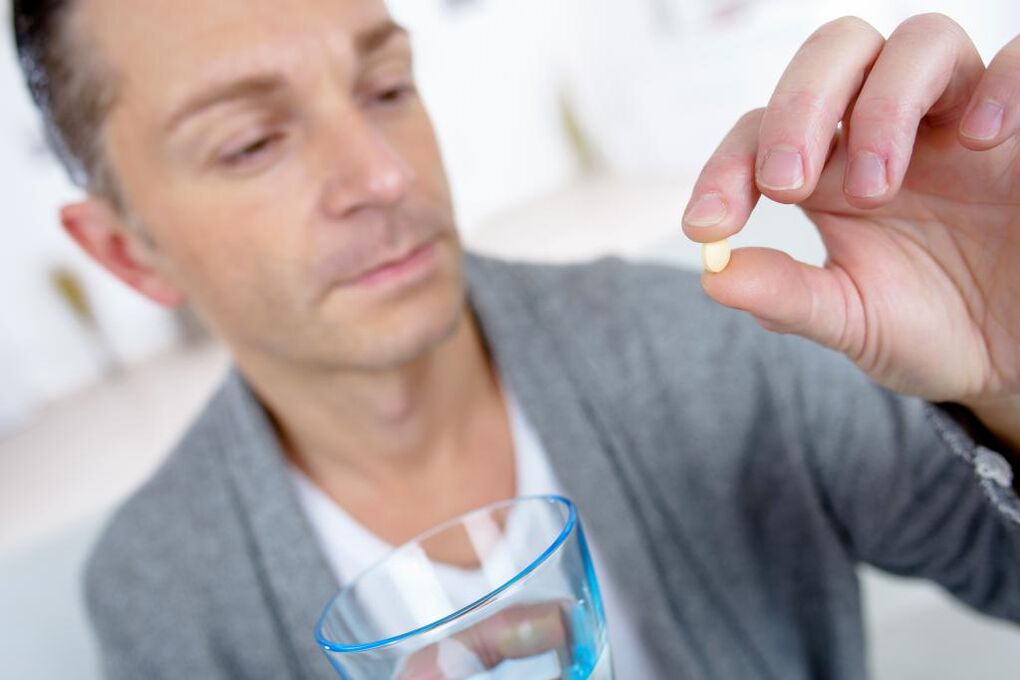 a man takes pills to increase potency